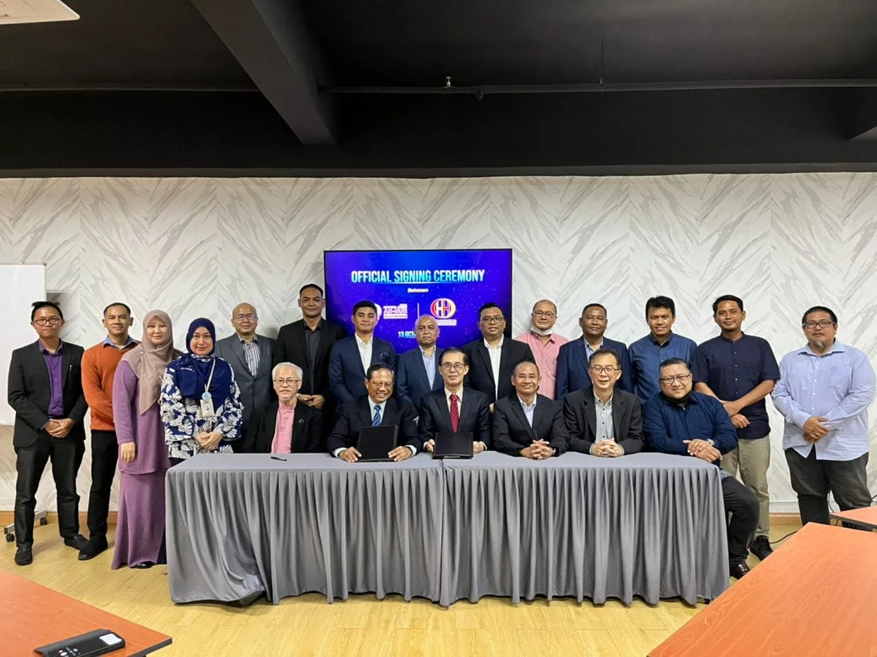 Group photograph at a signing ceremony with An-Nur